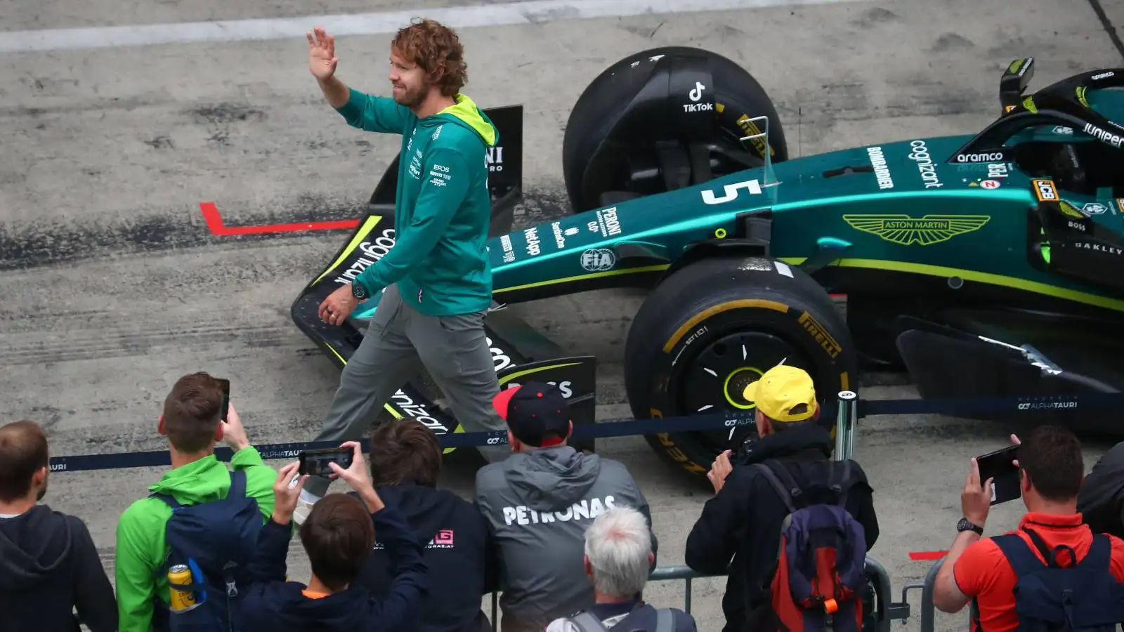 Sebastian Vettel waving next to his Aston Martin. Red Bull Ring July 2022.