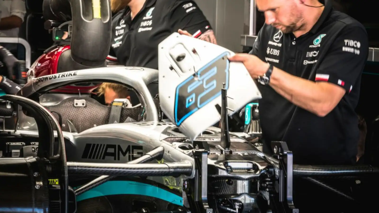 Mercedes mechanics working on George Russell's No63 W13 in the garage. Spain May 2022