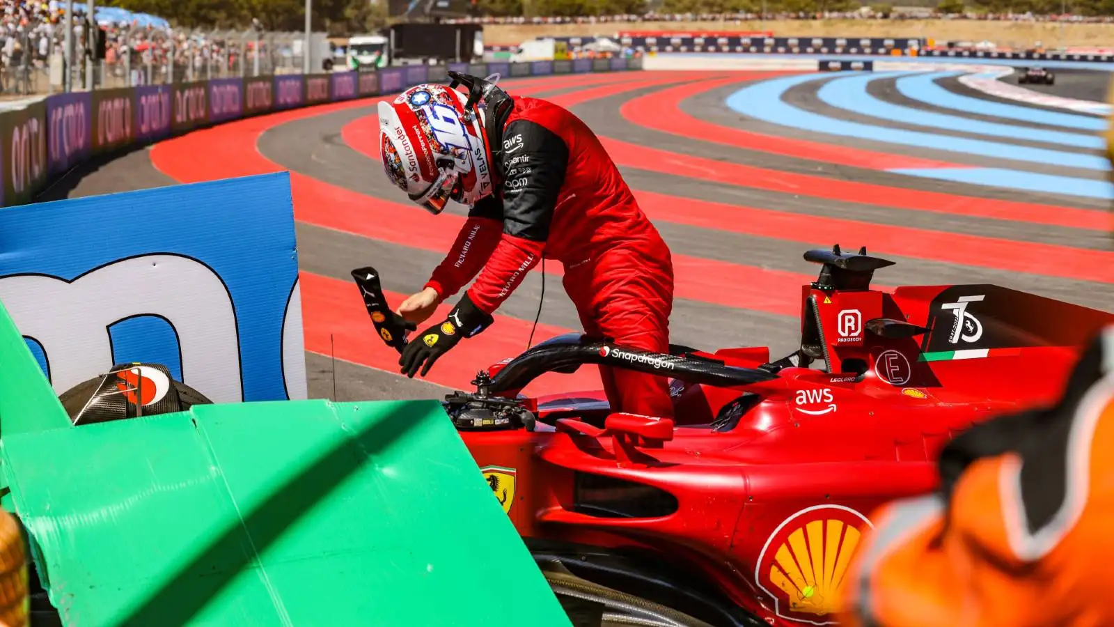 Charles Leclerc removes the steering wheel from his Ferrari after crashing. Paul Ricard July 2022.