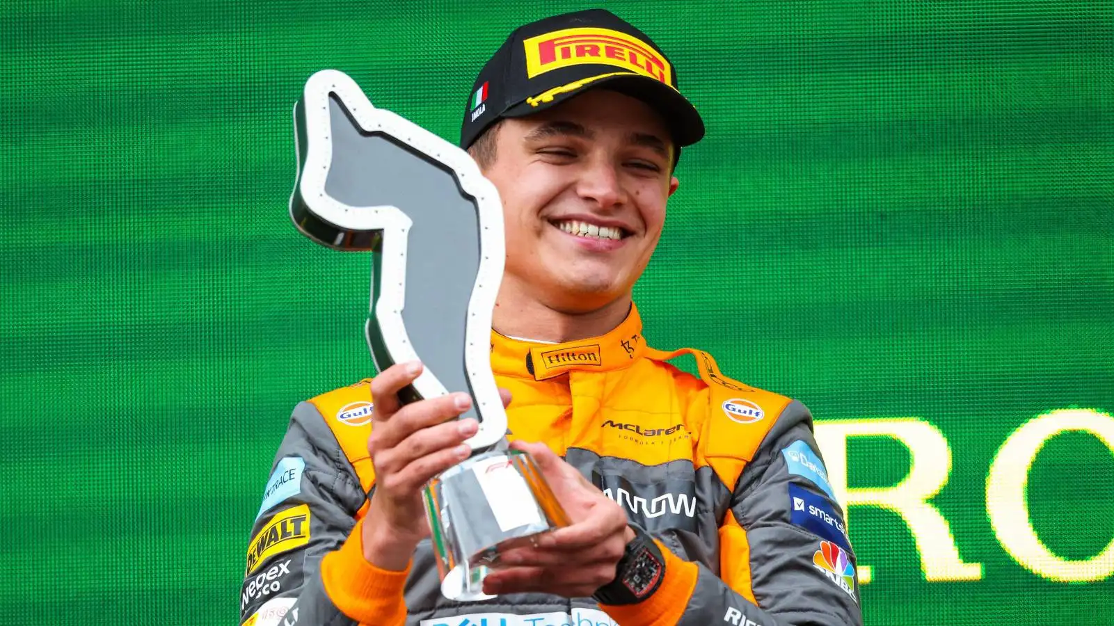 Lando Norris holds his trophy on the podium. Imola April 2022.