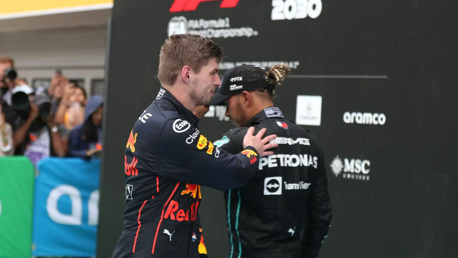 Max Verstappen pats Lewis Hamilton on the back. Hungary July 2022
