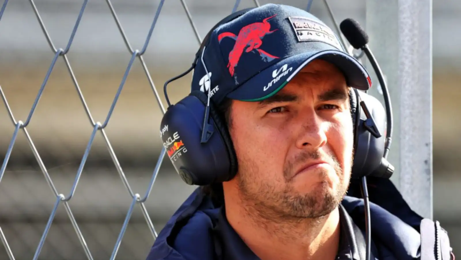 Sergio Perez not looking very happy, wearing headset. Barcelona February 2022