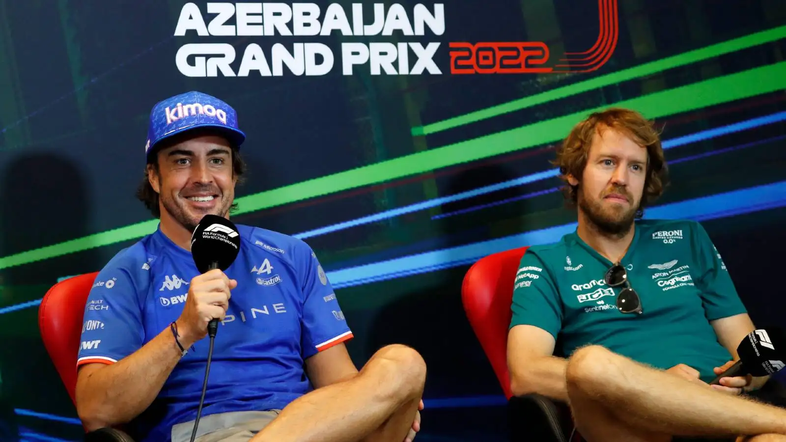 Fernando Alonso grinning next to Sebastian Vettel. Baku June 2022.