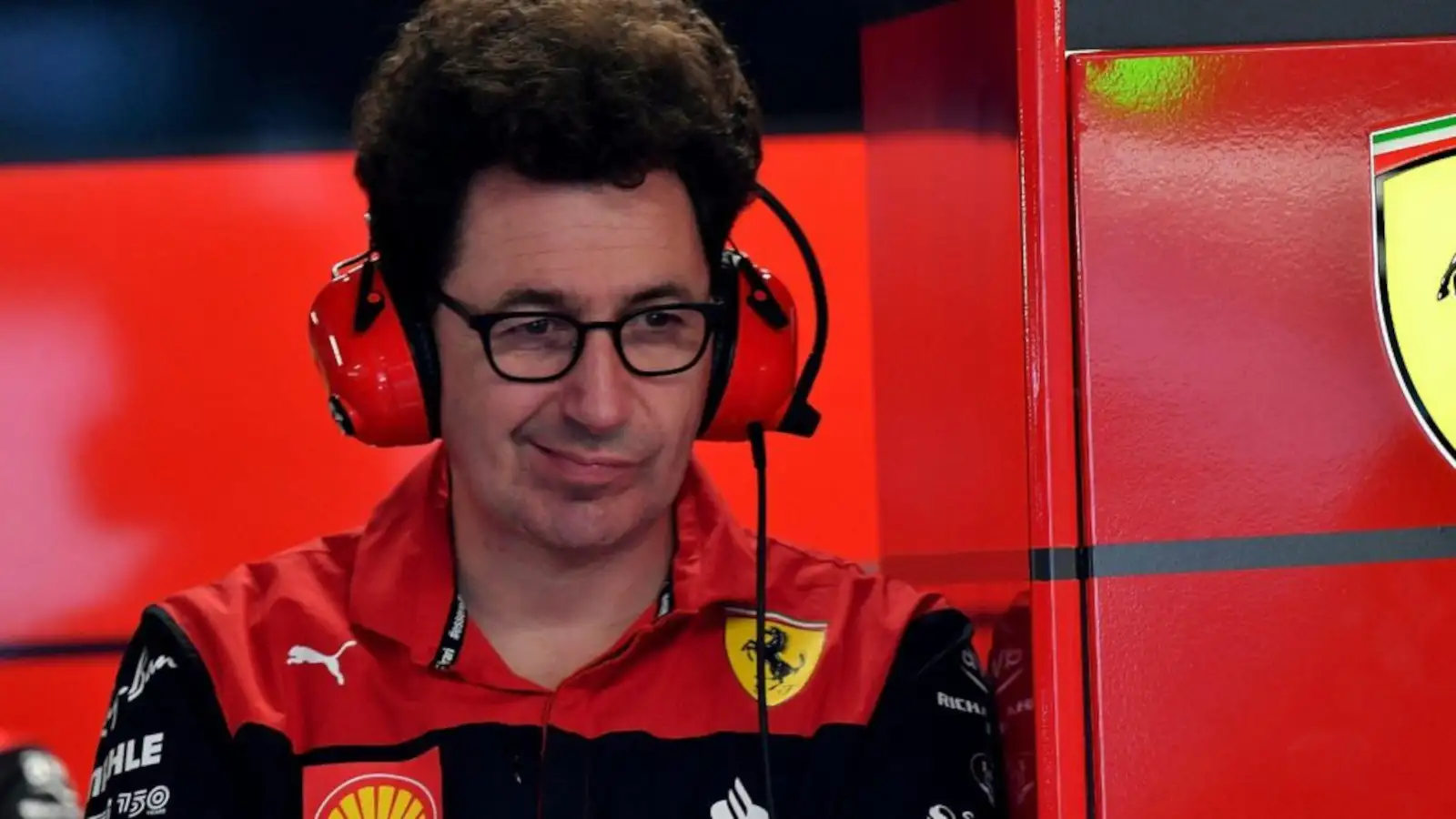 Ferrari team principal Mattia Binotto in the garage with headphones and a quirky look. Montreal June 2022