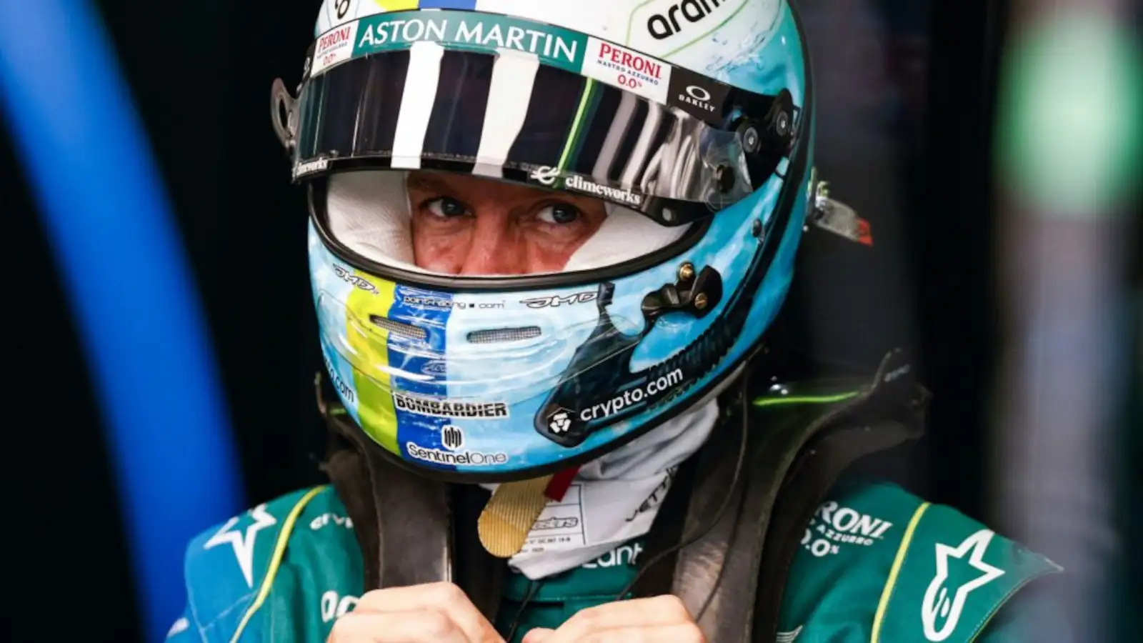 Sebastian Vettel in the garage with his helmet on looking at the camera. Miami May 2022