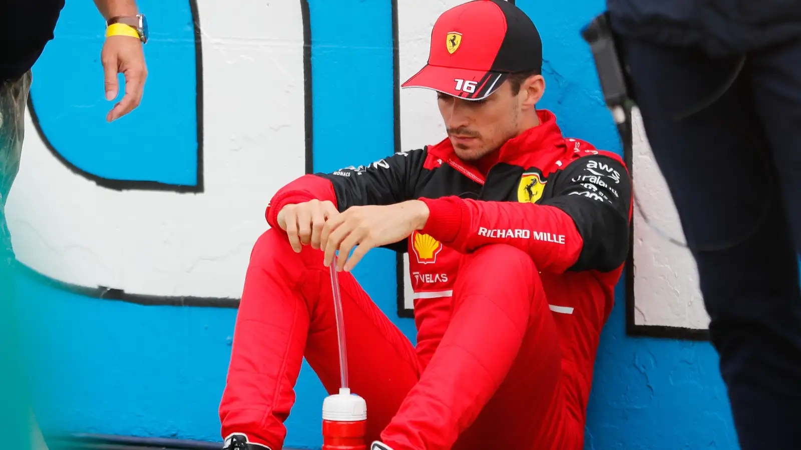 Charles Leclerc sitting against the wall on the starting grid. Hungary July 2022