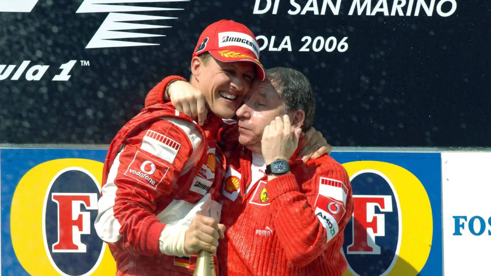 迈克尔-舒马赫hugs Ferrari boss Jean Todt. F1 Imola April 2006.