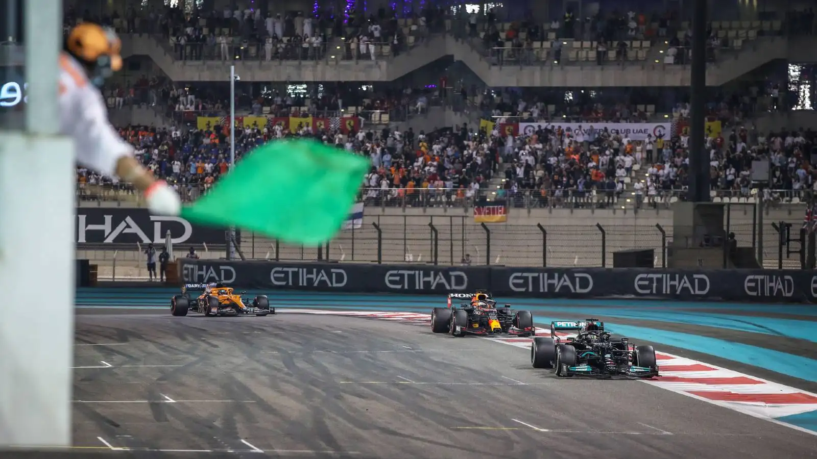 Lewis Hamilton leads Max Verstappen into the last lap of the Abu Dhabi GP. Yas Marina December 2021.