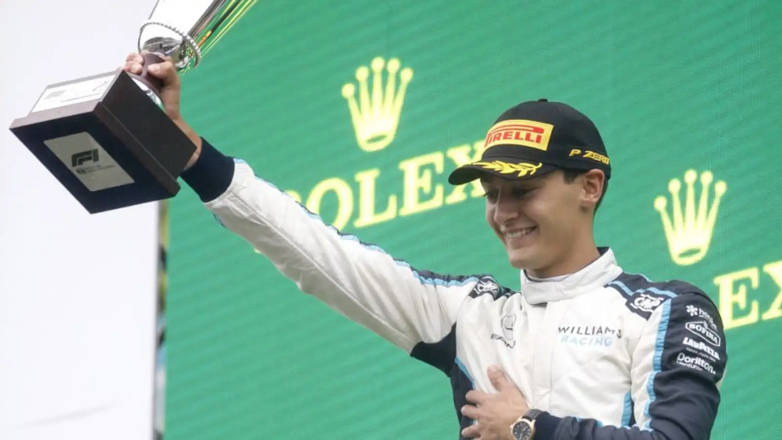 George Russell celebrates his first ever F1 podium, holding his trophy aloft. Belgium August 2021