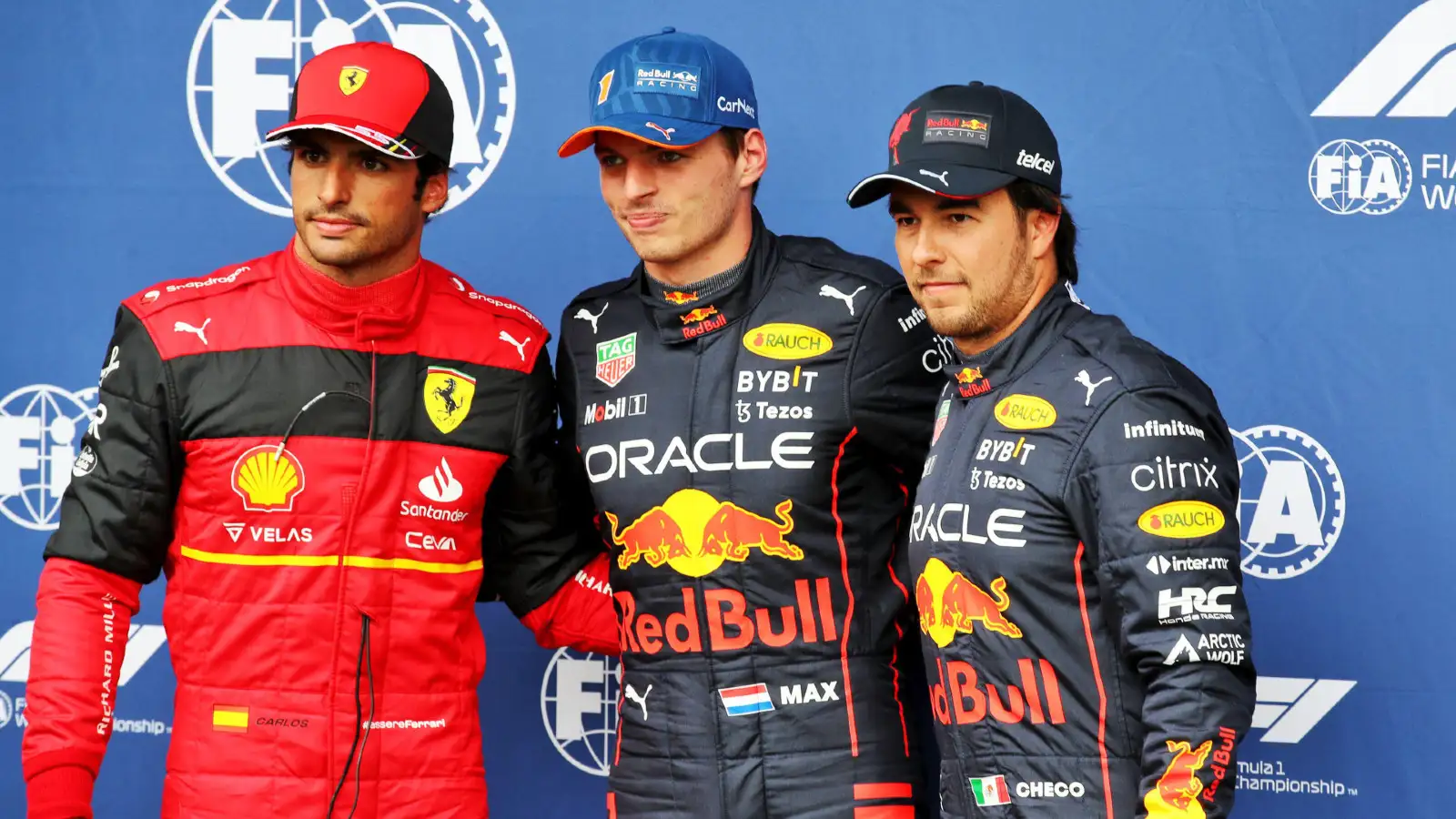 Red Bull's Max Verstappen celebrates pole position alongside Ferrari's Carlos Sainz and Red Bull's Sergio Perez. Spa-Francorchamps, August 2022.