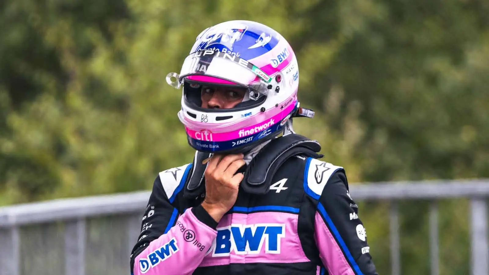 Fernando Alonso adjusts his helmet. Spa August 2022.