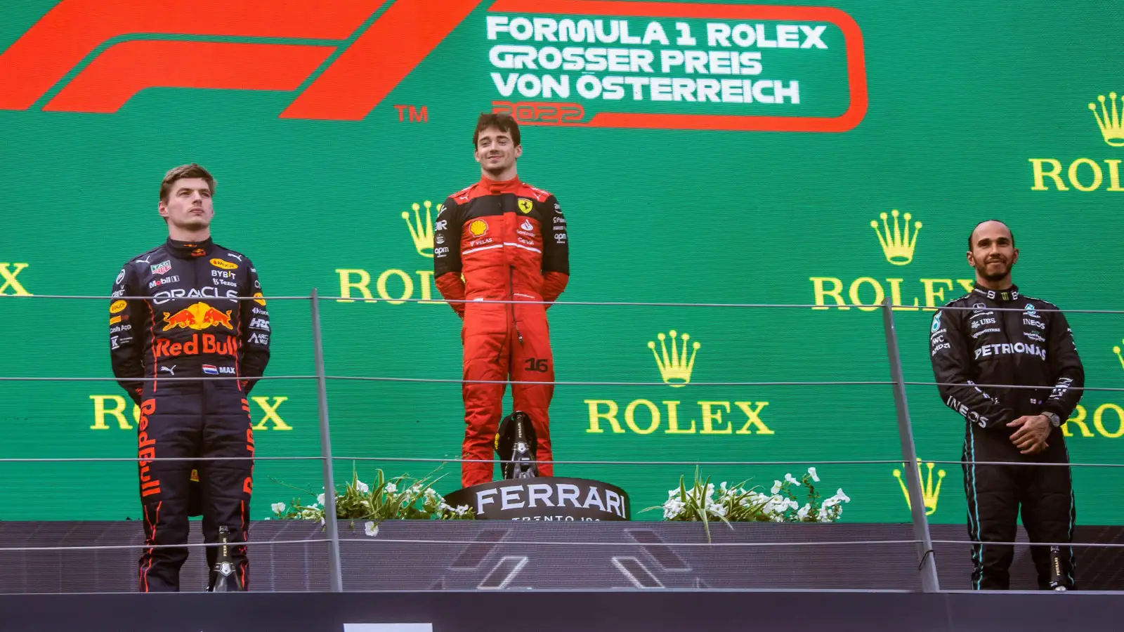 Red Bull's Max Verstappen, Ferrari's Charles Leclerc, and Mercedes' Lewis Hamilton on the podium at the Austrian Grand Prix. Spielberg, July 2022.