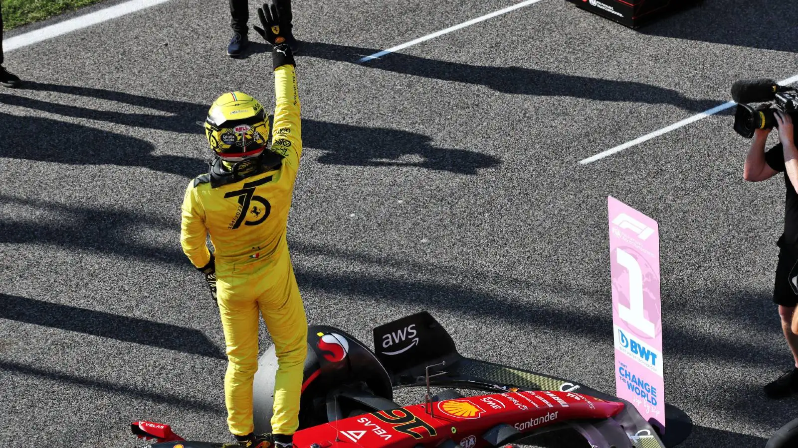 Charles Leclerc celebrates pole position in yellow race suit. Monza September 2022.