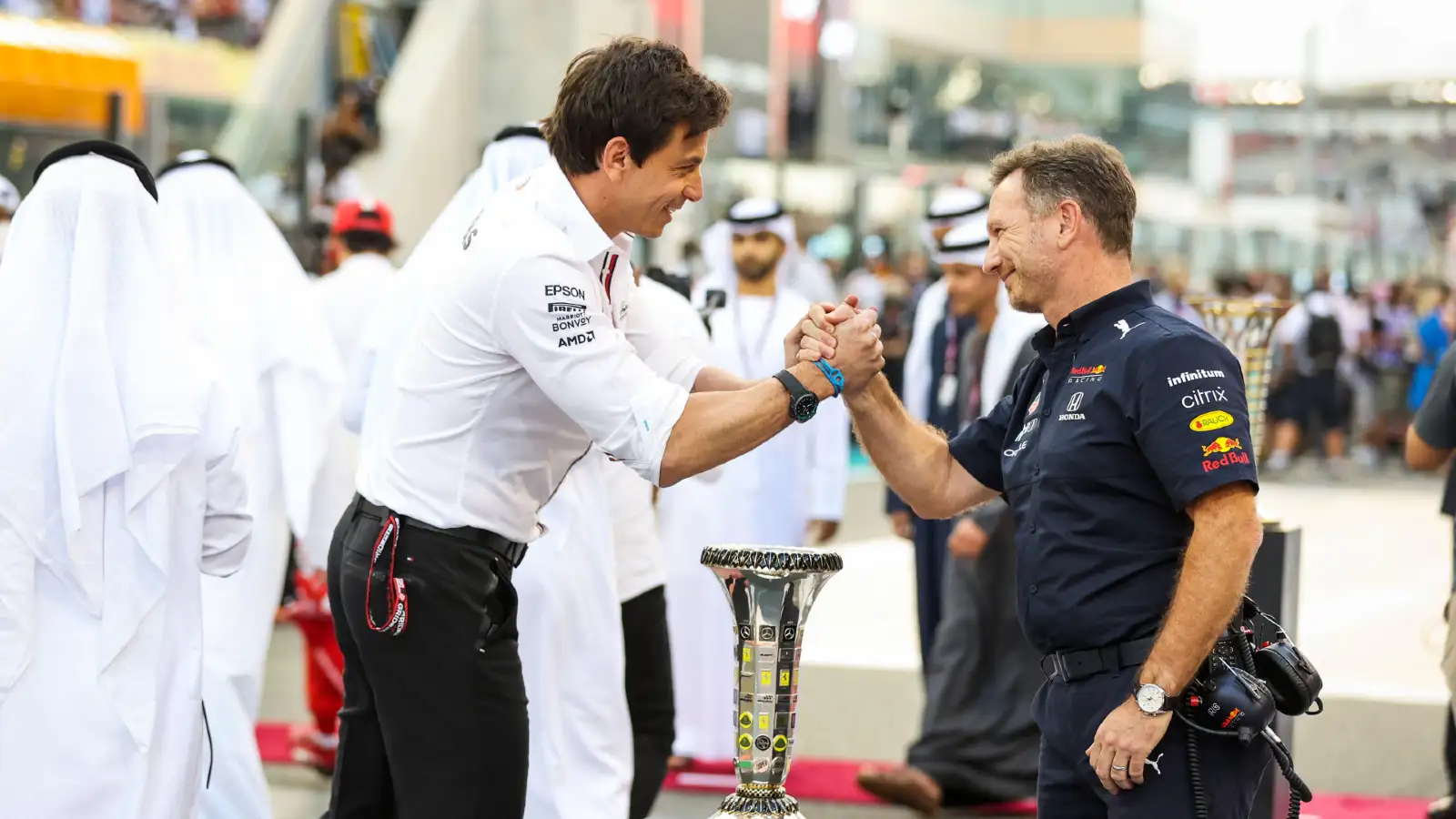 Mercedes' Toto Wolff and Red Bull's Christian Horner shake hands on the grid at the 2021 Abu Dhabi Grand Prix. Yas Marina, December 2021.