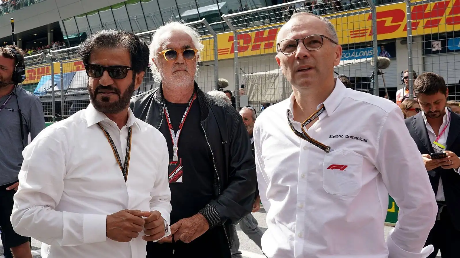 Flavio Briatore between FIA president Mohammed ben Sulayem and Stefano Domenicali. Red Bull Ring July 2022.