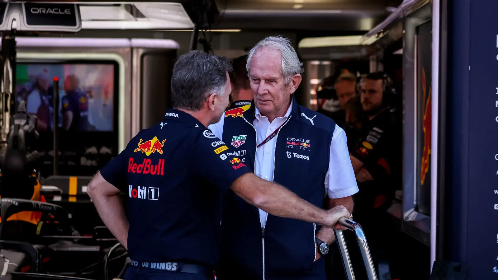 Red Bull motorsport advisor Helmut Marko speaking with Christian Horner in the garage.