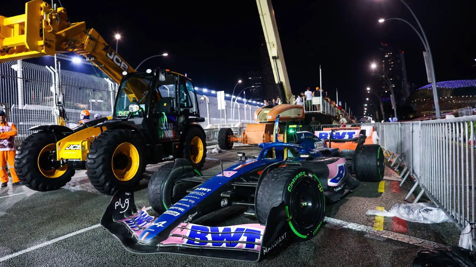 Esteban Ocon's Alpine car next to a cherry-picker. Marina Bay October 2022.