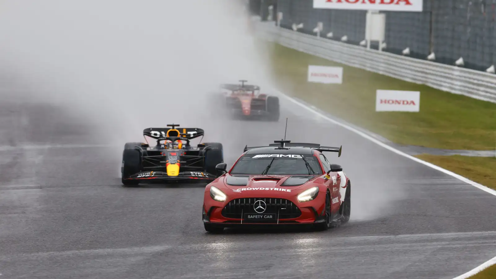 The FIA Mercedes Safety Car leads Max Verstappen, a lot of spray. Japan October 2022
