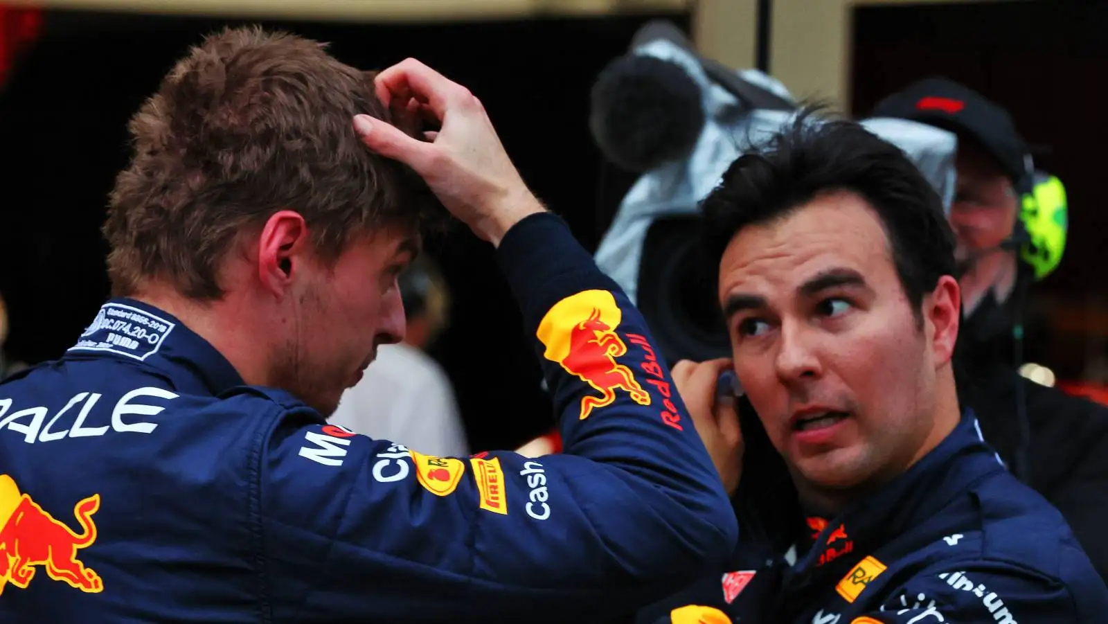 Max Verstappen, Red Bull, scratching head next to Sergio Perez. Suzuka October 2022.