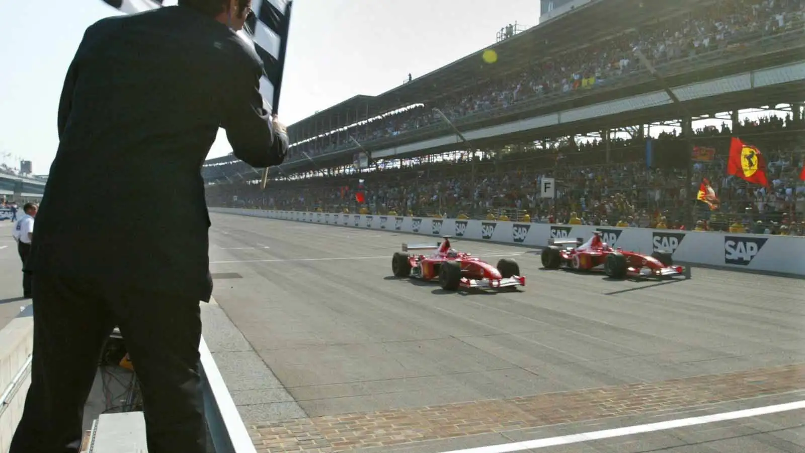Michael Schumacher and Rubens Barrichello cross the line. Indianapolis September 2002.