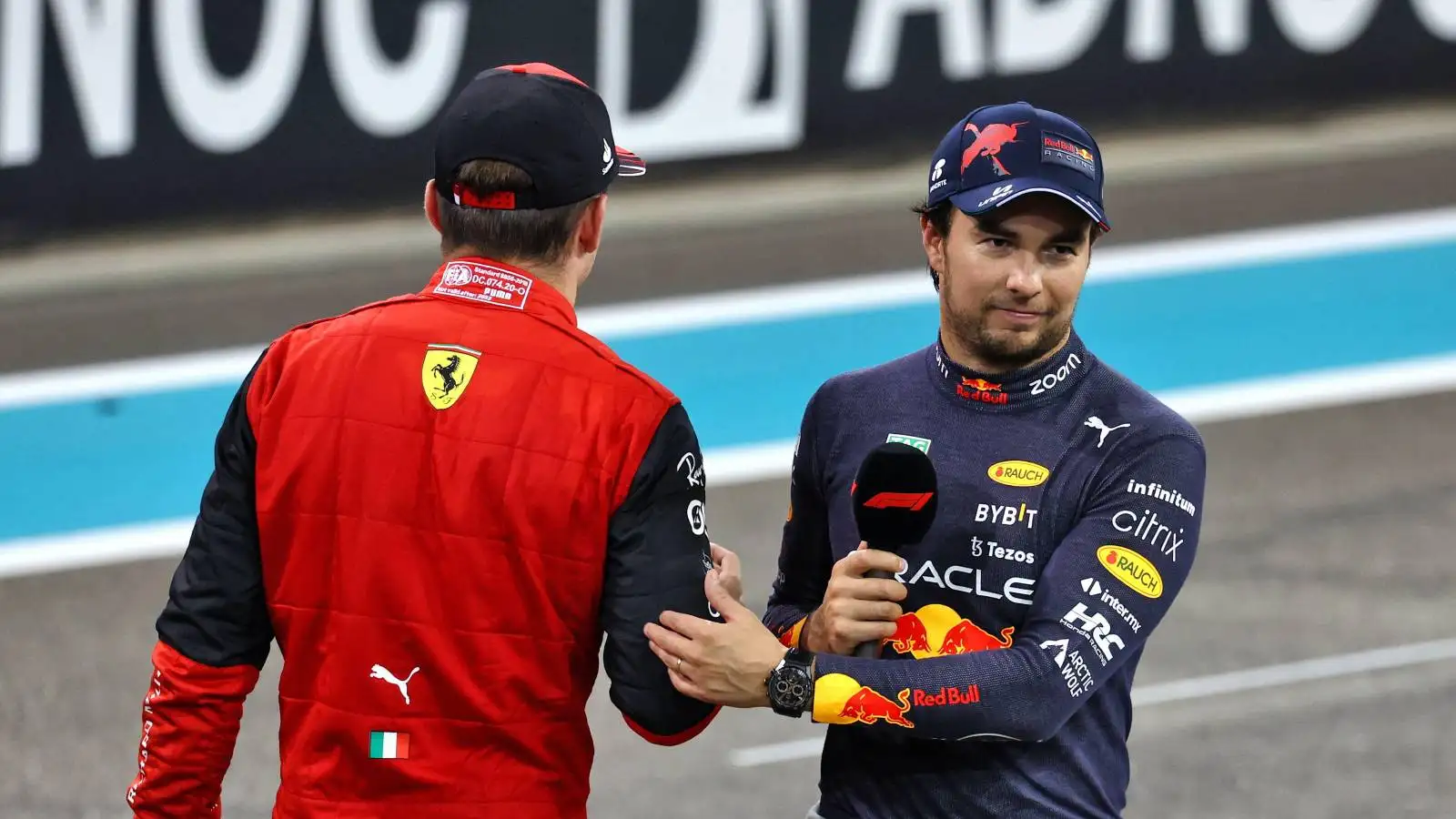 Charles Leclerc, Ferrari and Sergio Perez, Red Bull, acknowledge each other. Abu Dhabi, November 2022.