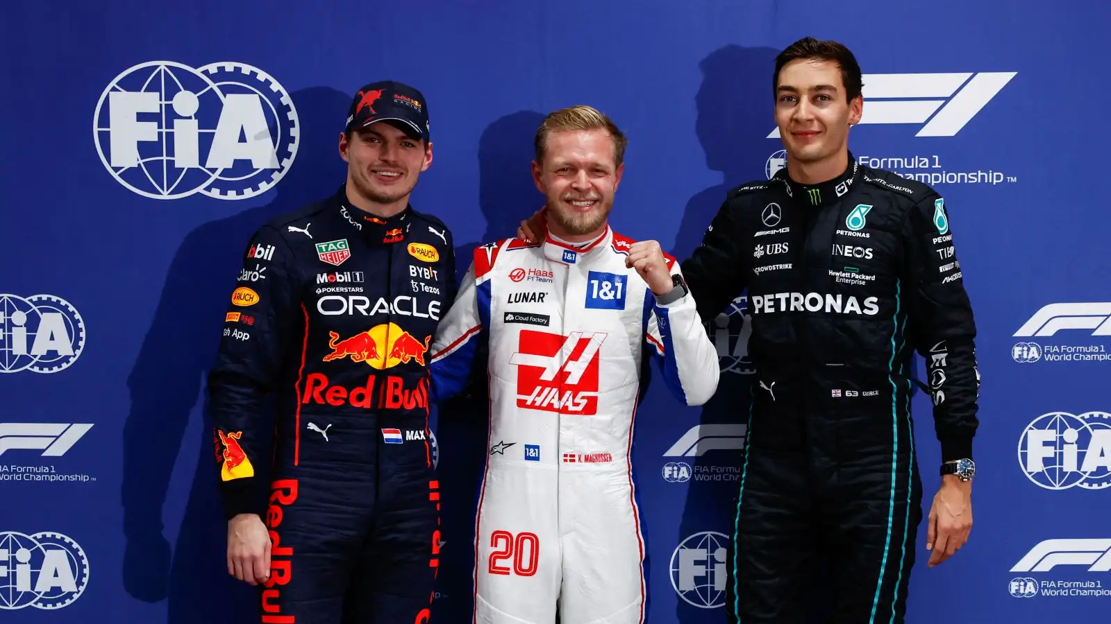 Kevin Magnussen celebrates pole alongside Max Verstappen and George Russell. Sao Paulo, November 2022.