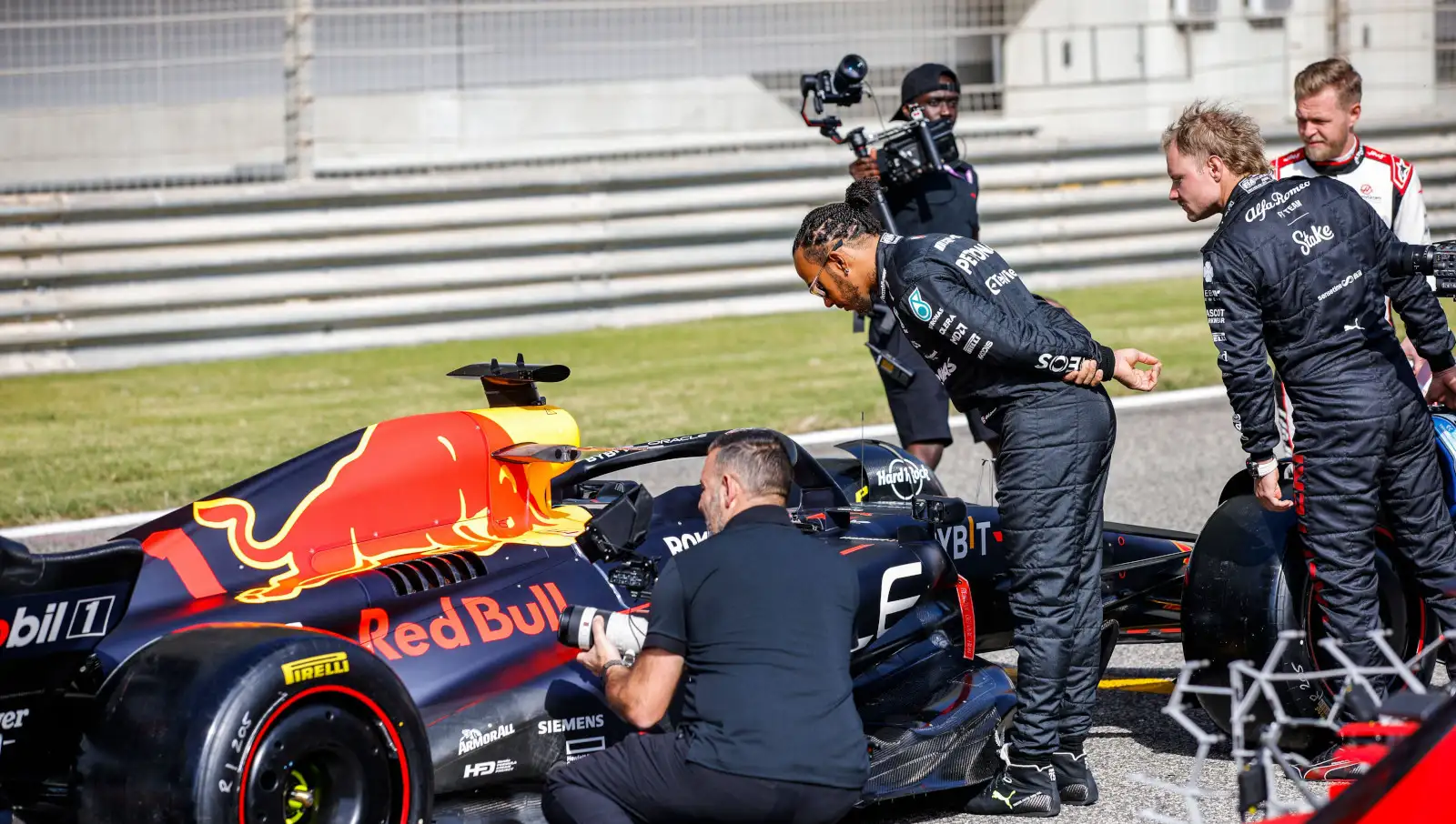Mercedes driver Lewis Hamilton Valtteri Bottas Kevin Magnussen looking at Red Bull RB19. Bahrain February 2023