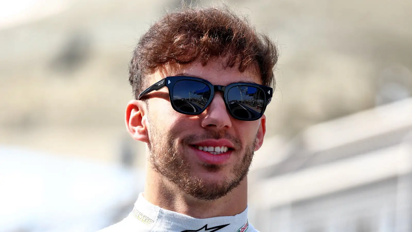 Pierre Gasly smiling whilst wearing sunglasses. Bahrain, February 2023.