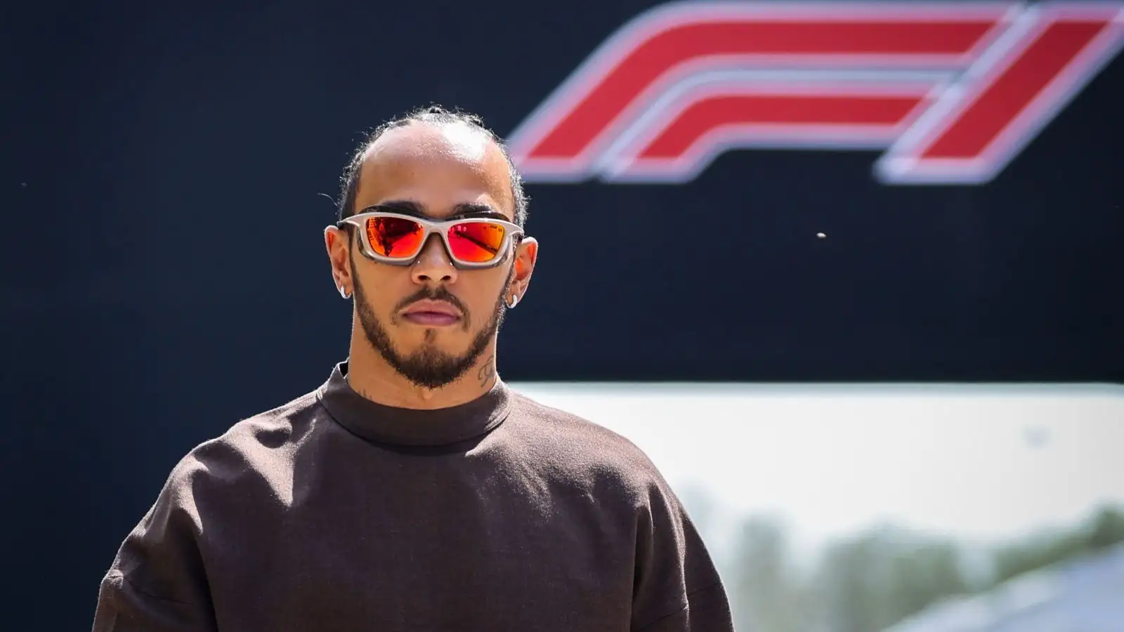 Lewis Hamilton, with the Formula 1 logo behind him in Bahrain.