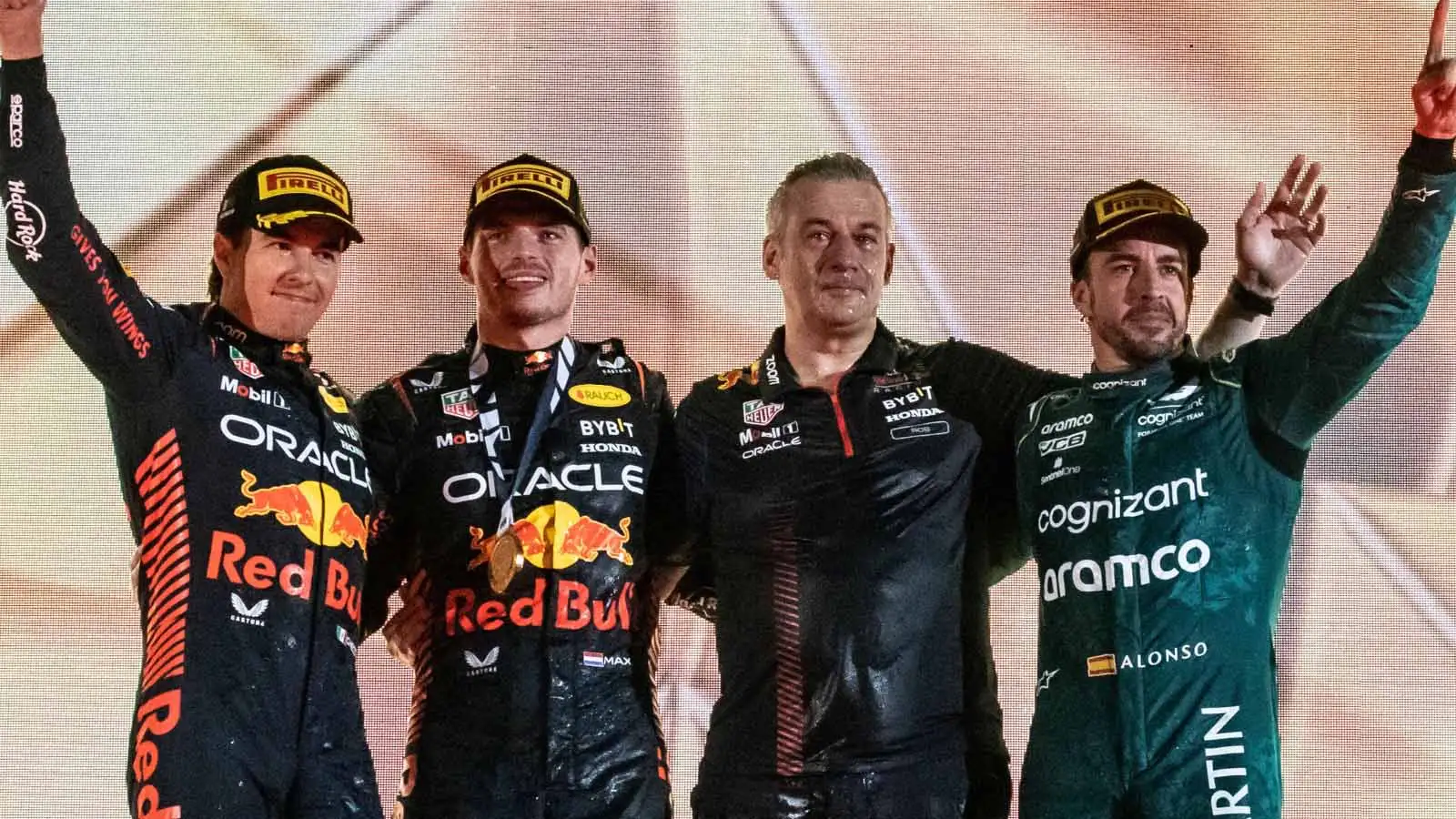 Red Bull drivers Max Verstappen and Sergio Perez alongside Aston Martin driver Fernando Alonso on the podium. Bahrain March 2023.