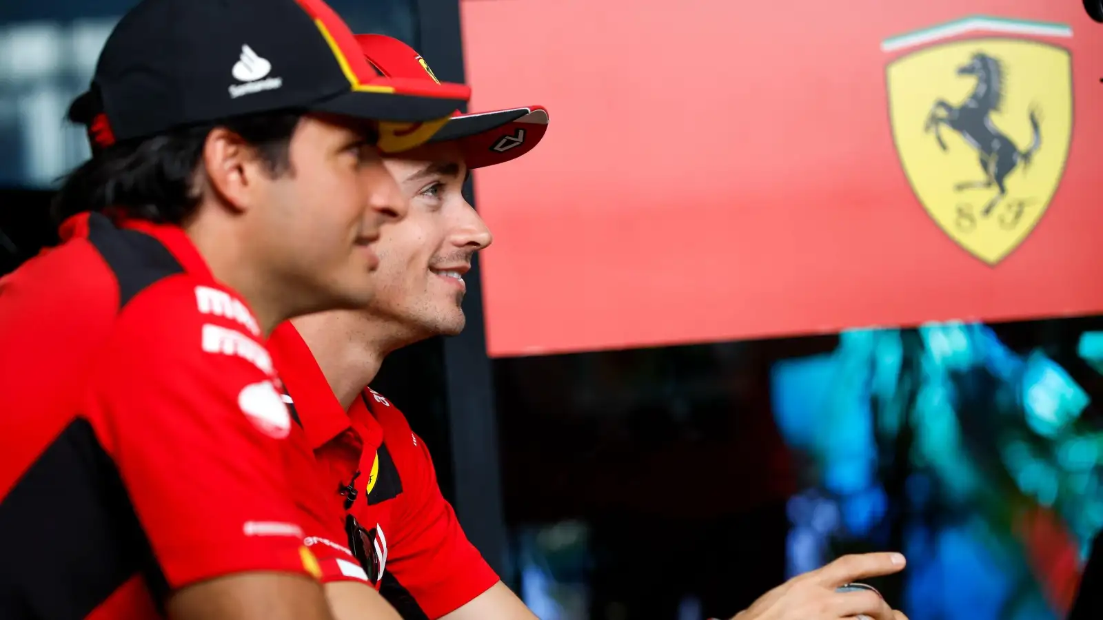 Ferrari drivers Carlos Sainz and Charles Leclerc smiling. Saudi Arabia, March 2023.