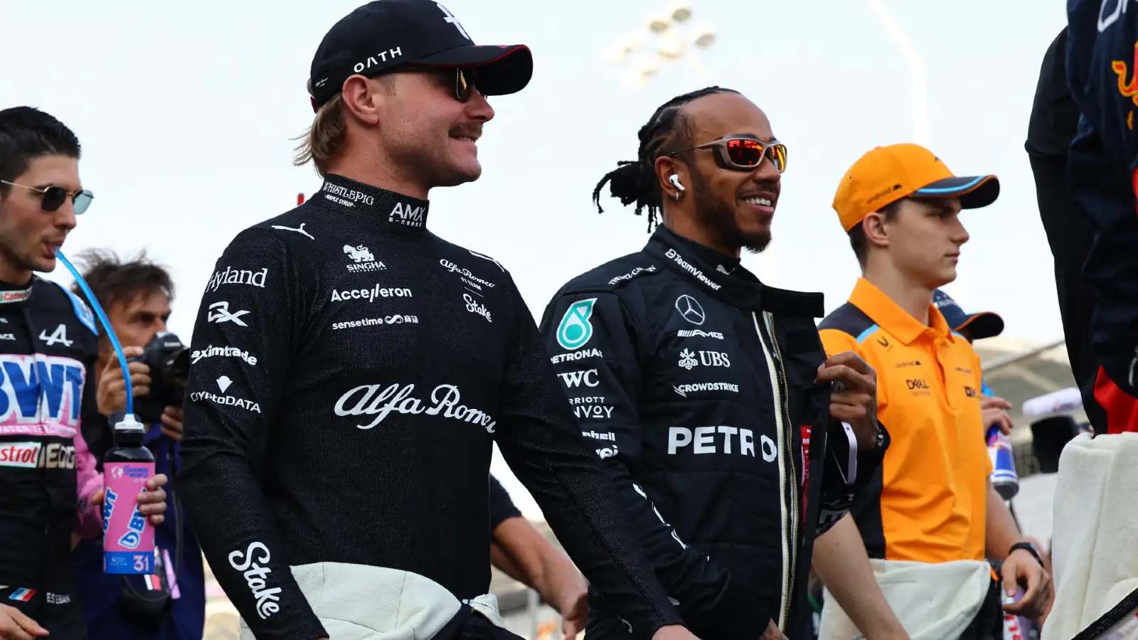 Mercedes driver Lewis Hamilton chats with Alfa Romeo driver Valtteri Bottas. Bahrain, March 2023.