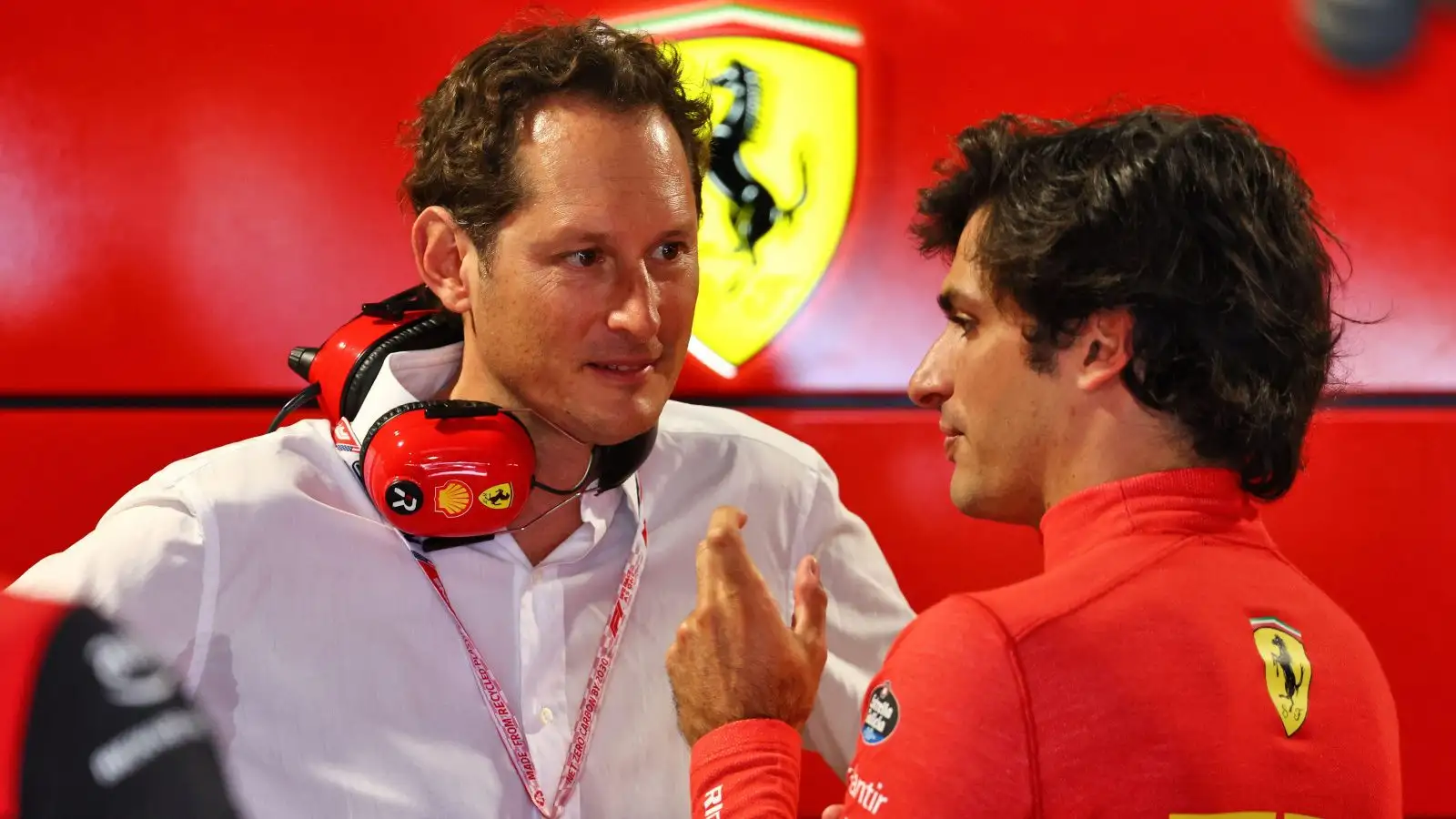 Ferrari's John Elkann speaks with Carlos Sainz at the 2022 Miami Grand Prix.