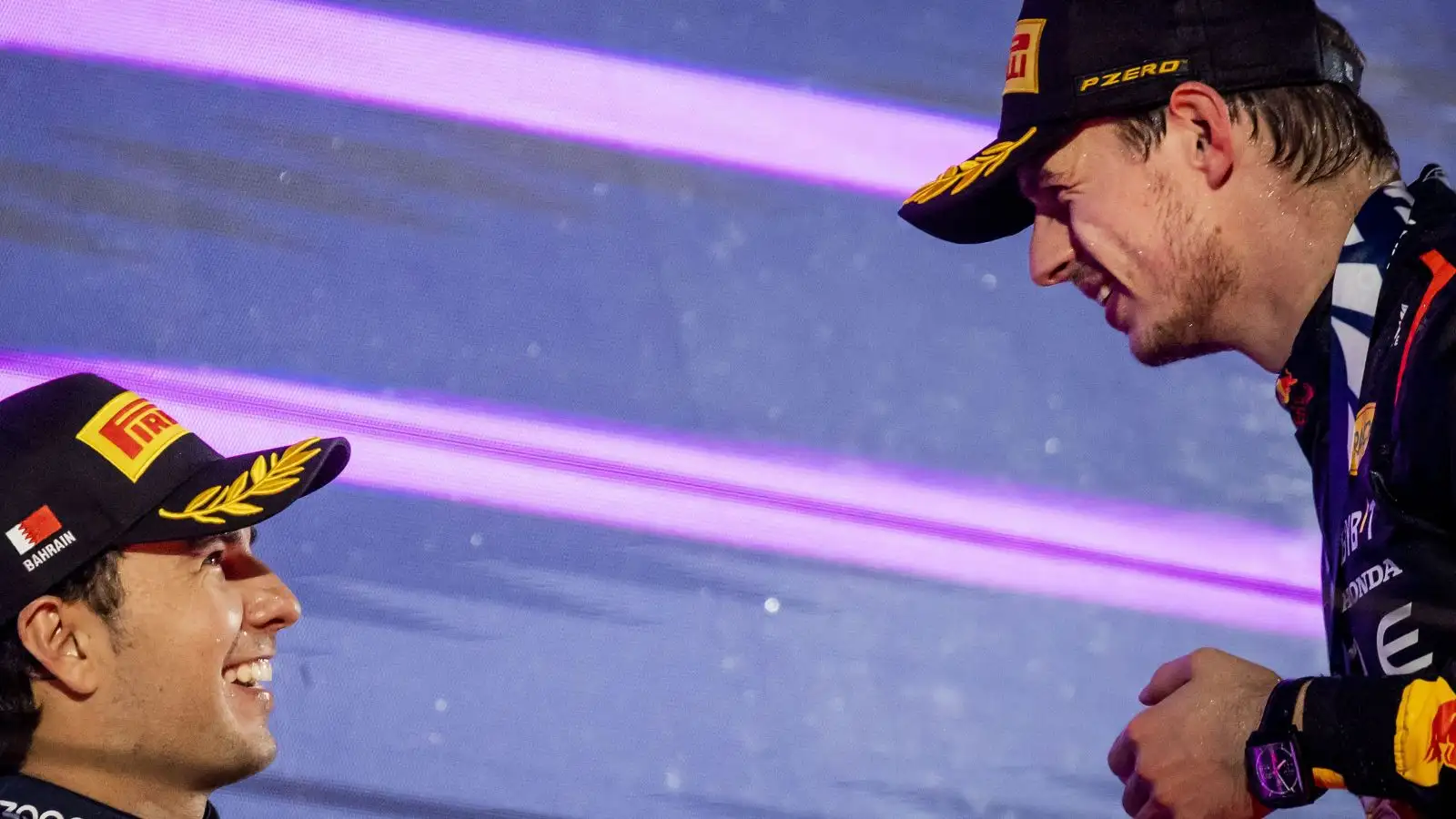 Max Verstappen acknowledges Sergio Perez on the podium after Red Bull one-two finish. F1 Bahrain, 2023.