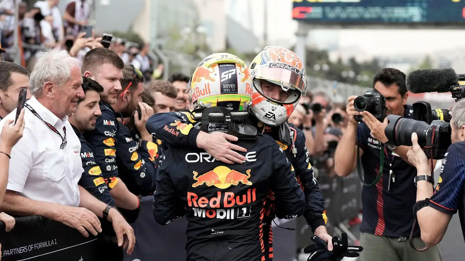 Red Bull's Sergio Perez and Max Verstappen embrace after the Azerbaijan Grand Prix. Baku, April 2023.