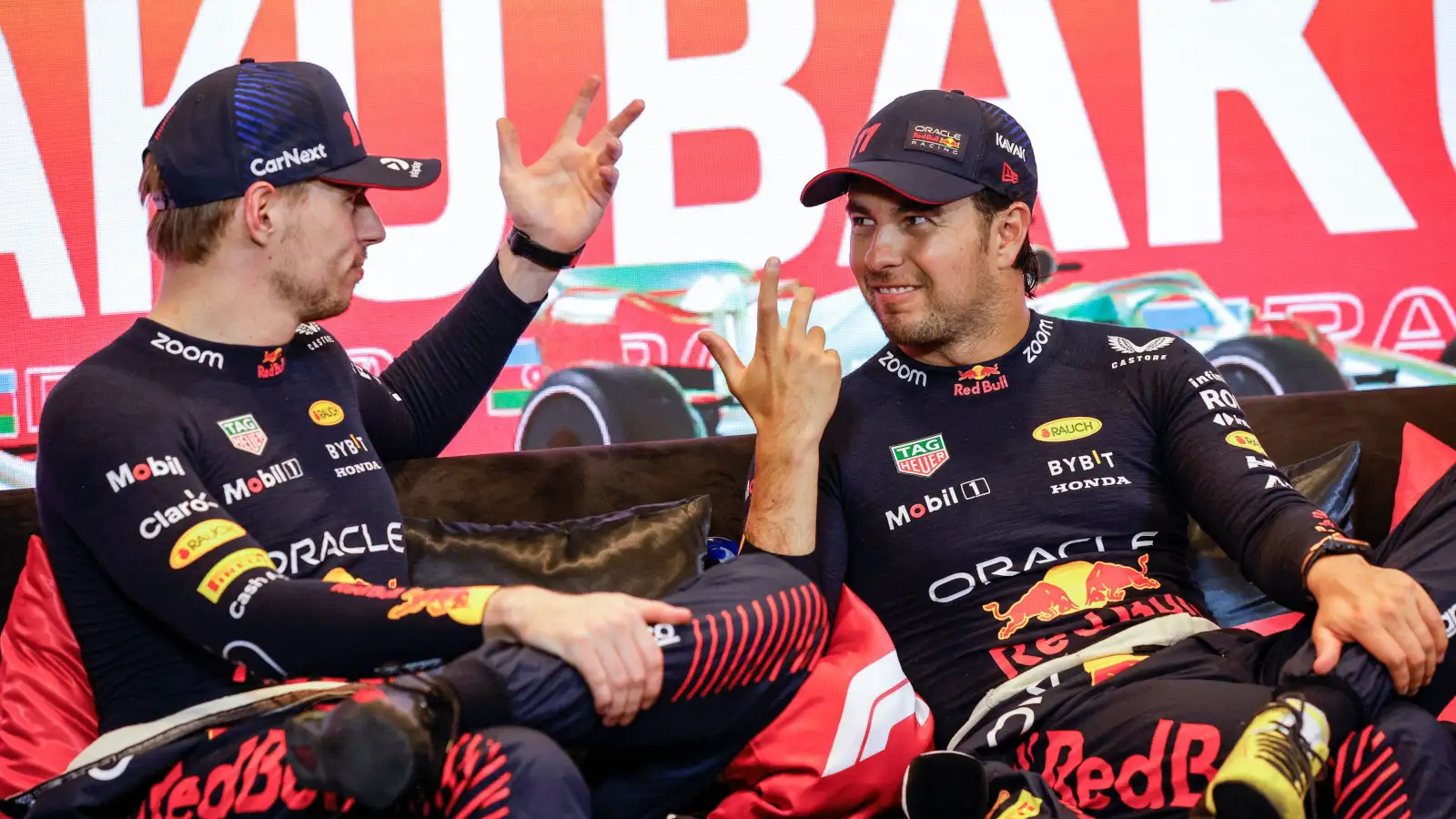 Sergio Perez smiling with Max Verstappen in the press conference. Azerbaijan April 2023