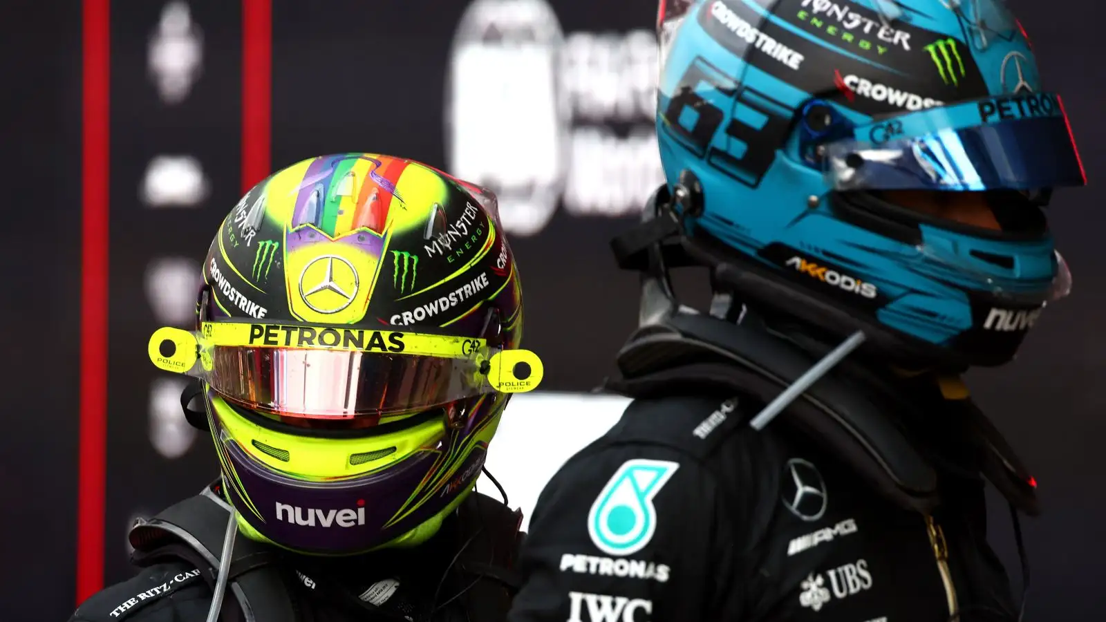 Mercedes drivers Lewis Hamilton and George Russell look on in parc ferme at the end of the Azerbaijan Grand Prix. Baku, 2023.