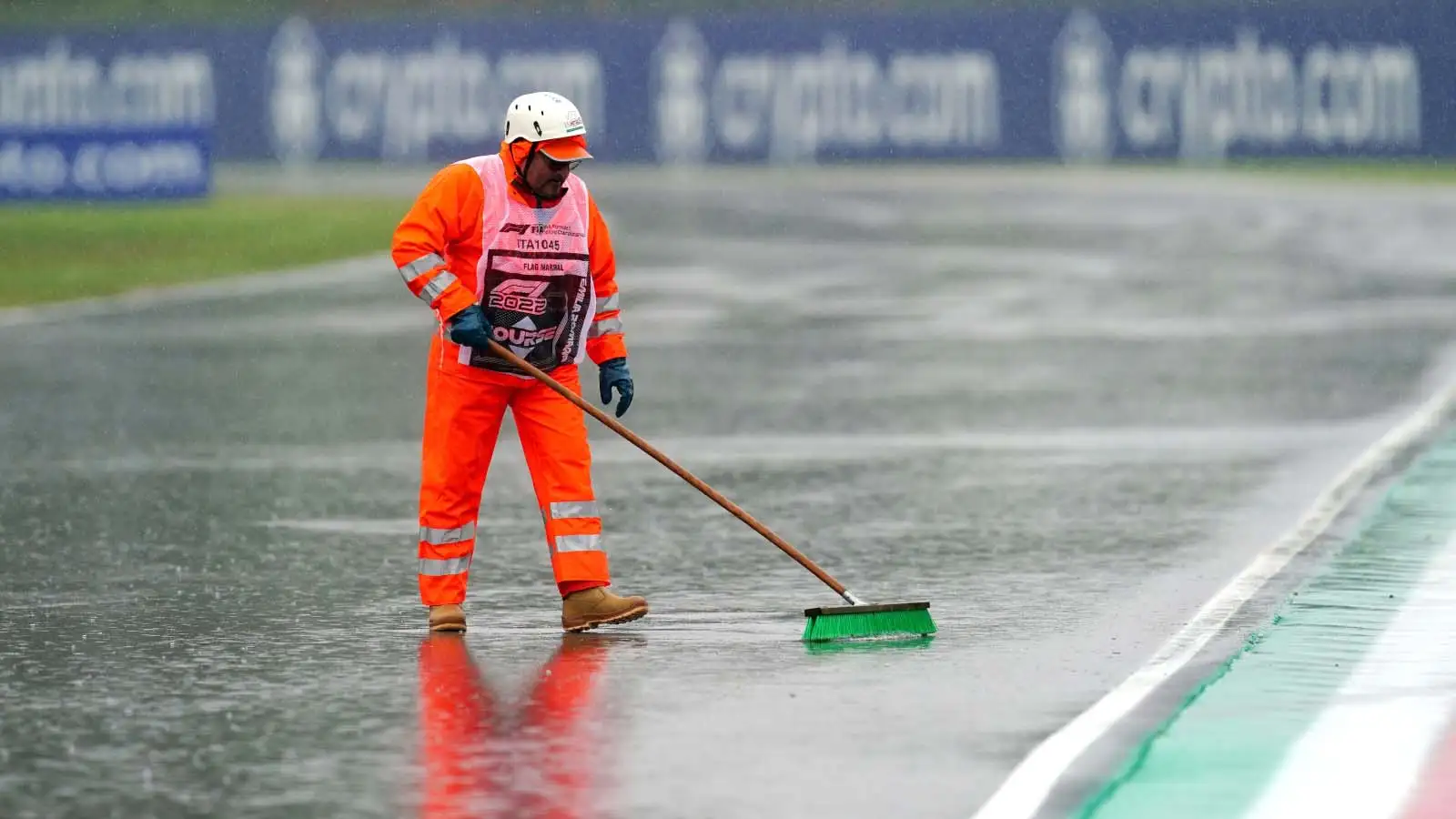 A marshal sweeps rain off track. Imola May 2022.