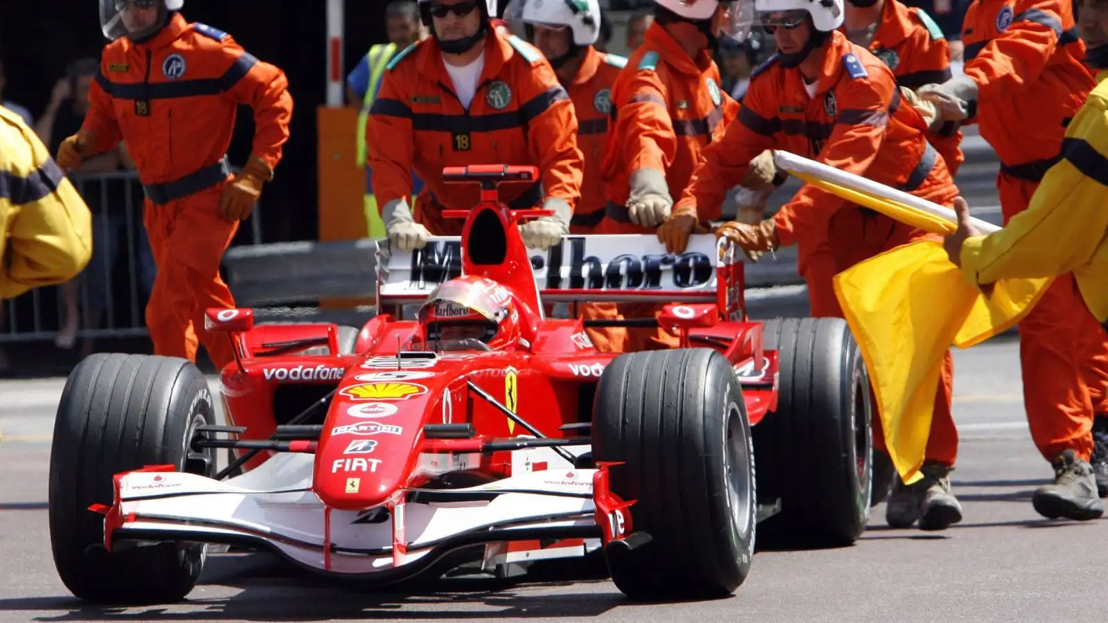 Michael Schumacher's Ferrari is wheeled away by the marshals after the seven-time World Champion parked at the Rascasse corner in the dying moments of Monaco Grand Prix qualifying. Monte Carlo, May 2006.