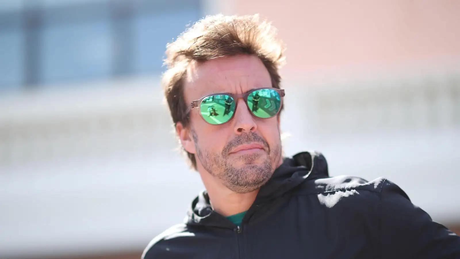 Aston Martin driver Fernando Alonso arrives at the Monaco paddock.