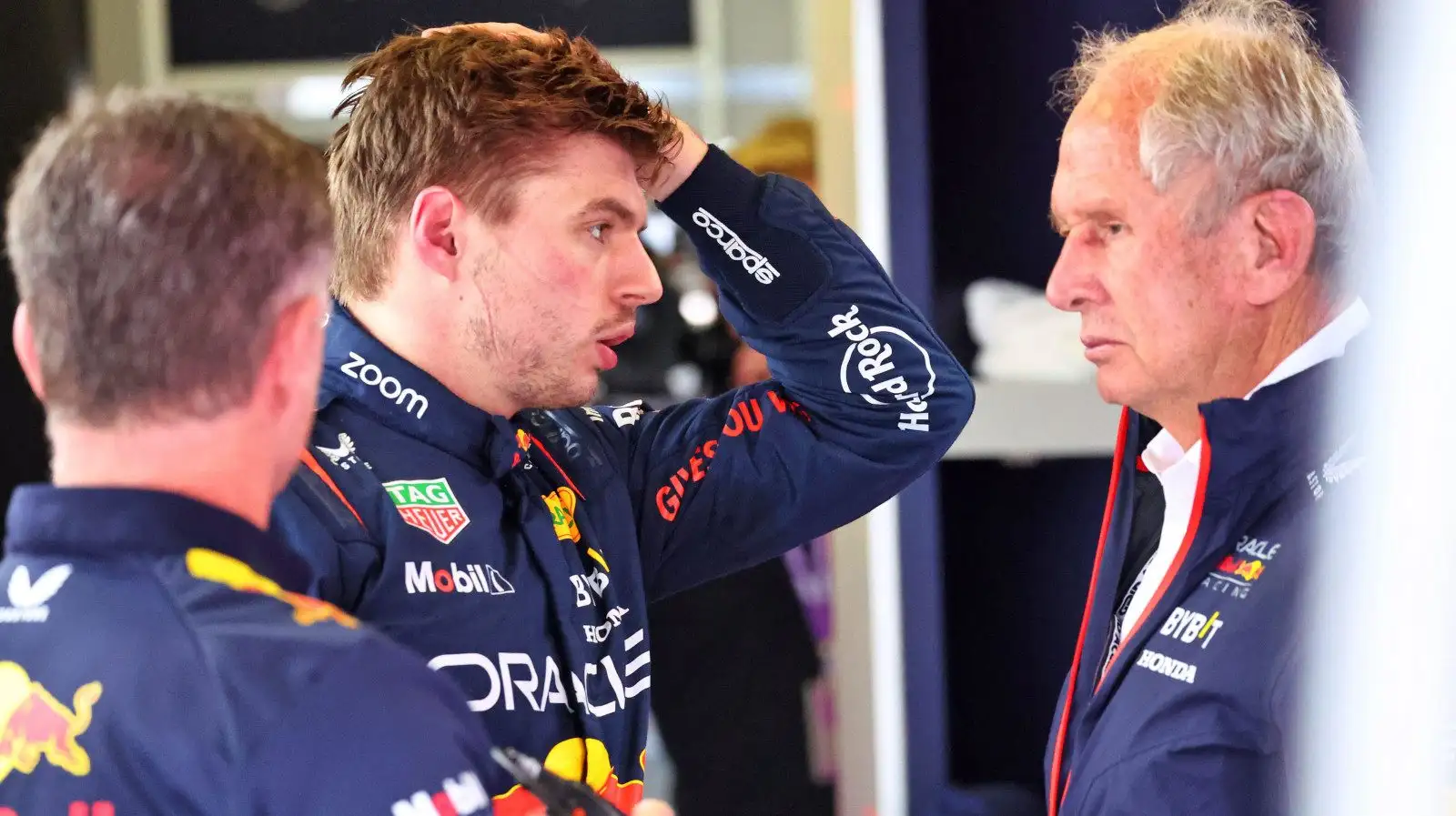 Red Bull driver Max Verstappen with his hand to his head, speaking with Helmut Marko and Christian Horner. Baku April 2023