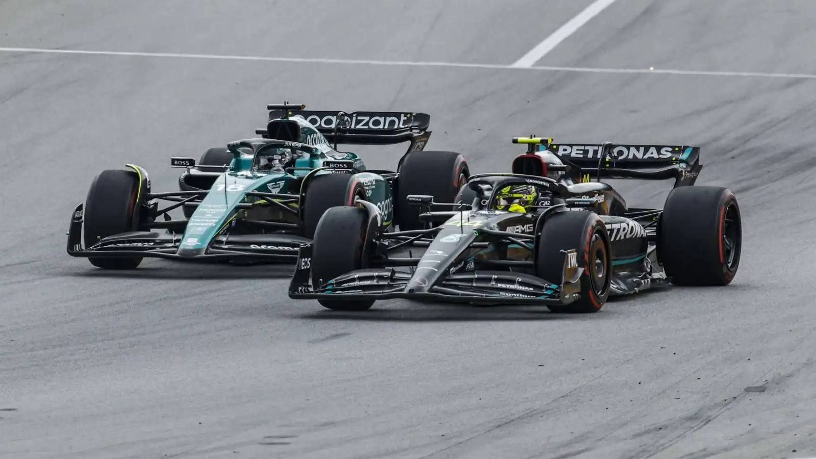 Lance Stroll, Aston Martin and Lewis Hamilton, Mercedes, battle. Spain, June 2023.