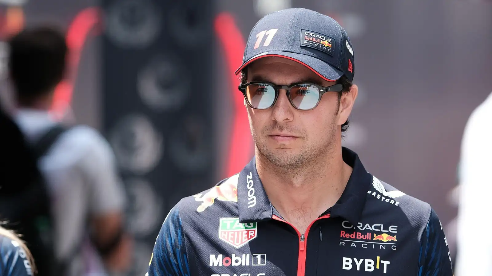 Sergio Perez, Red Bull, walks through the paddock.