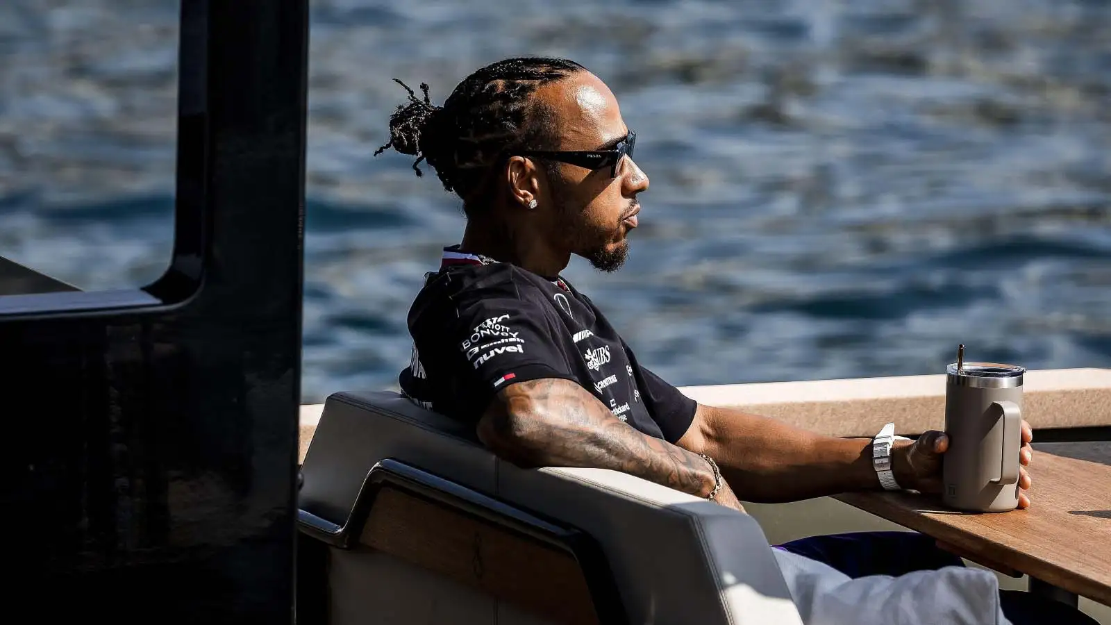 Lewis Hamilton sits with a drink. F1 Monaco May 2023.