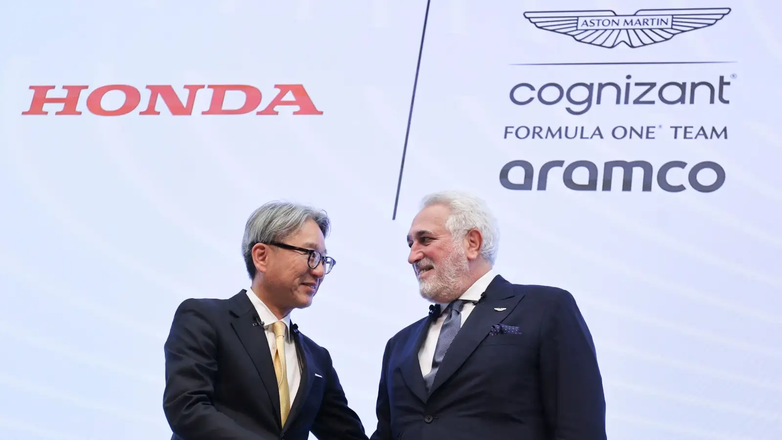 Honda Motor Co. President Toshihiro Mibe and Aston Martin Executive Chairman Lawrence Stroll shake hands. Tokyo, May 2023.