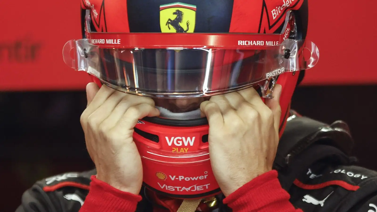 Charles Leclerc with his hands to his visor. Ferrari Canada June 2023