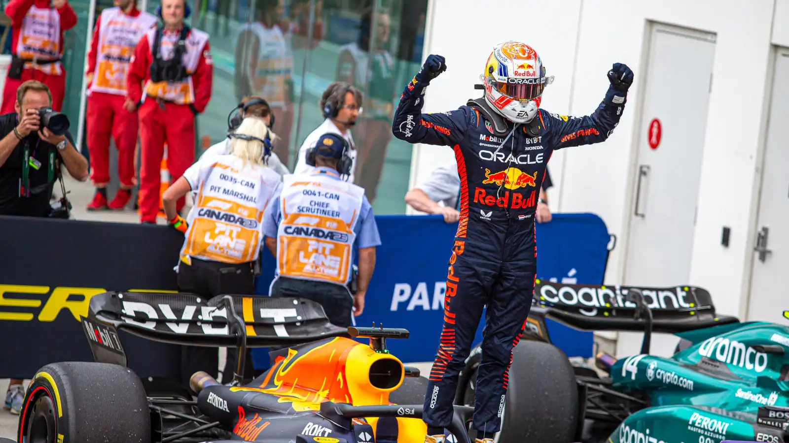 Max Verstappen stands on his RB19 and celebrates. Canada June 2023