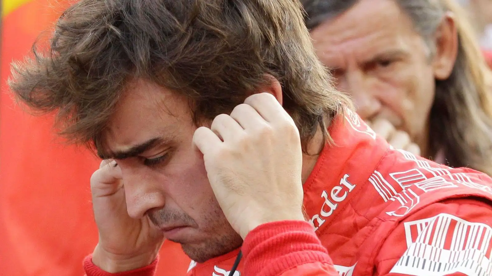 Ferrari driver Fernando Alonso looks tense on the grid shortly before the start of the F1 title-deciding Abu Dhabi Grand Prix.