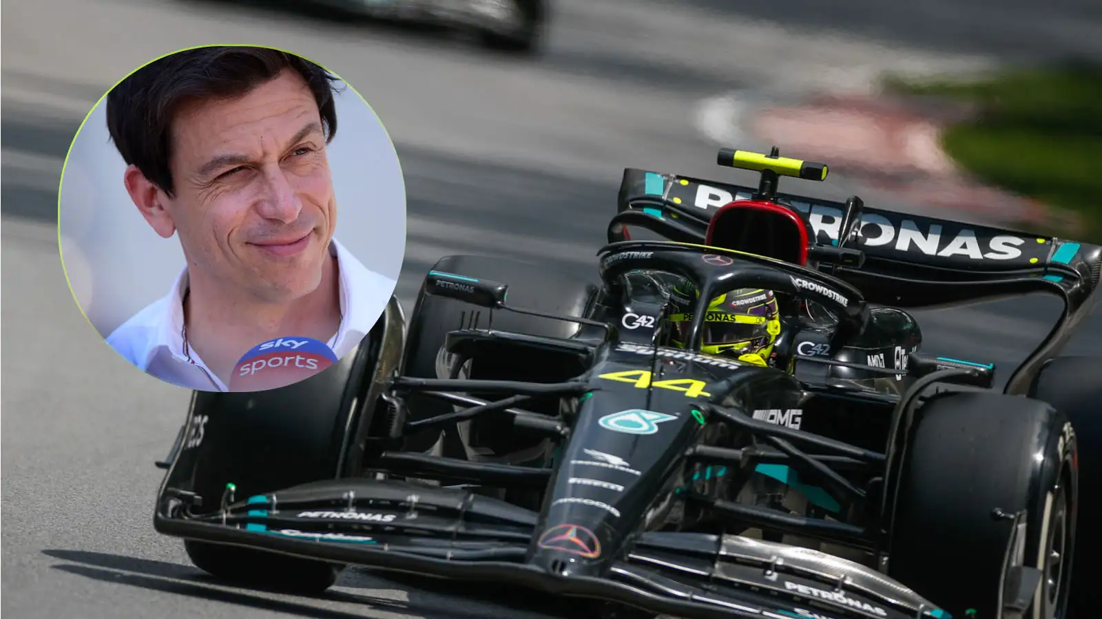 Toto Wolff alongside Lewis Hamilton's Mercedes W14. June 2023