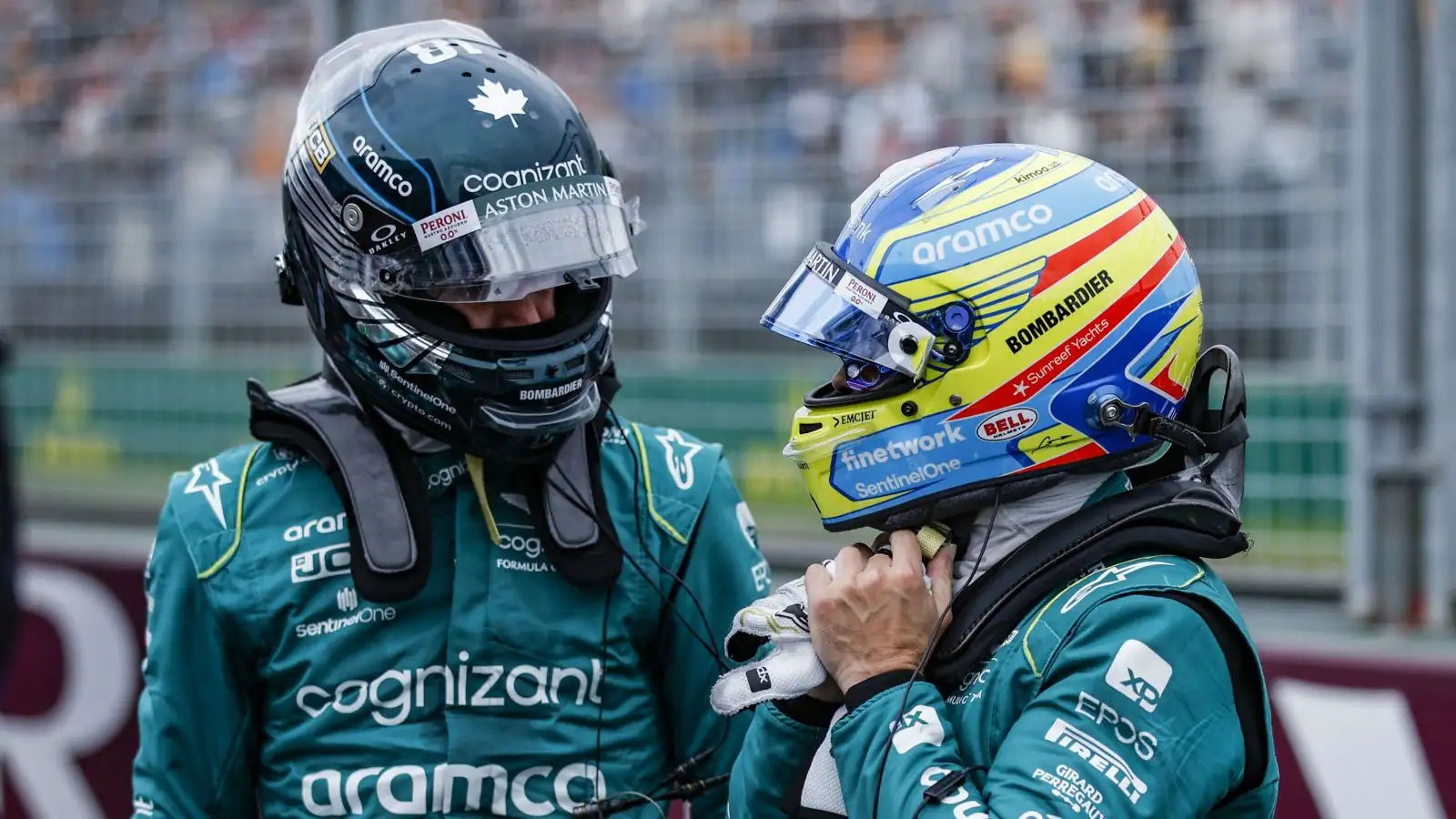 Aston Martin drivers Lance Stroll and Fernando Alonso in conversation at the conclusion of Australian Grand Prix qualifying. Melbourne, April 2023.